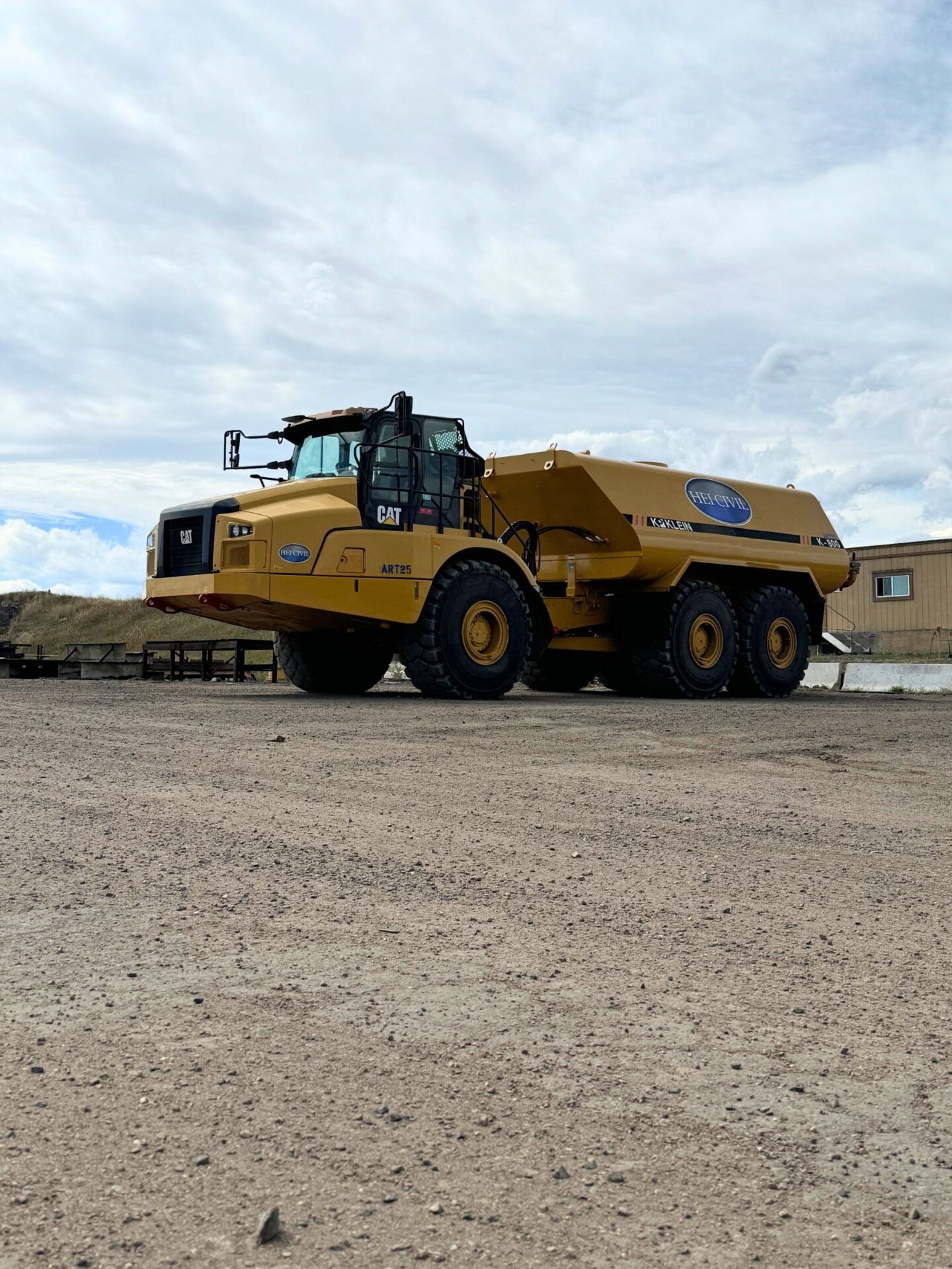 Articulated dump truck that has been equipped with a water tank for construction purposes