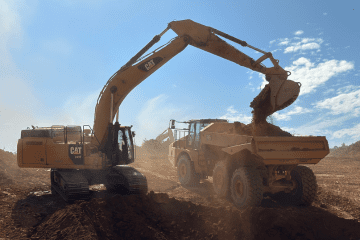 HEI Civil Carolinas Excavator and Dump Truck on a Job Site