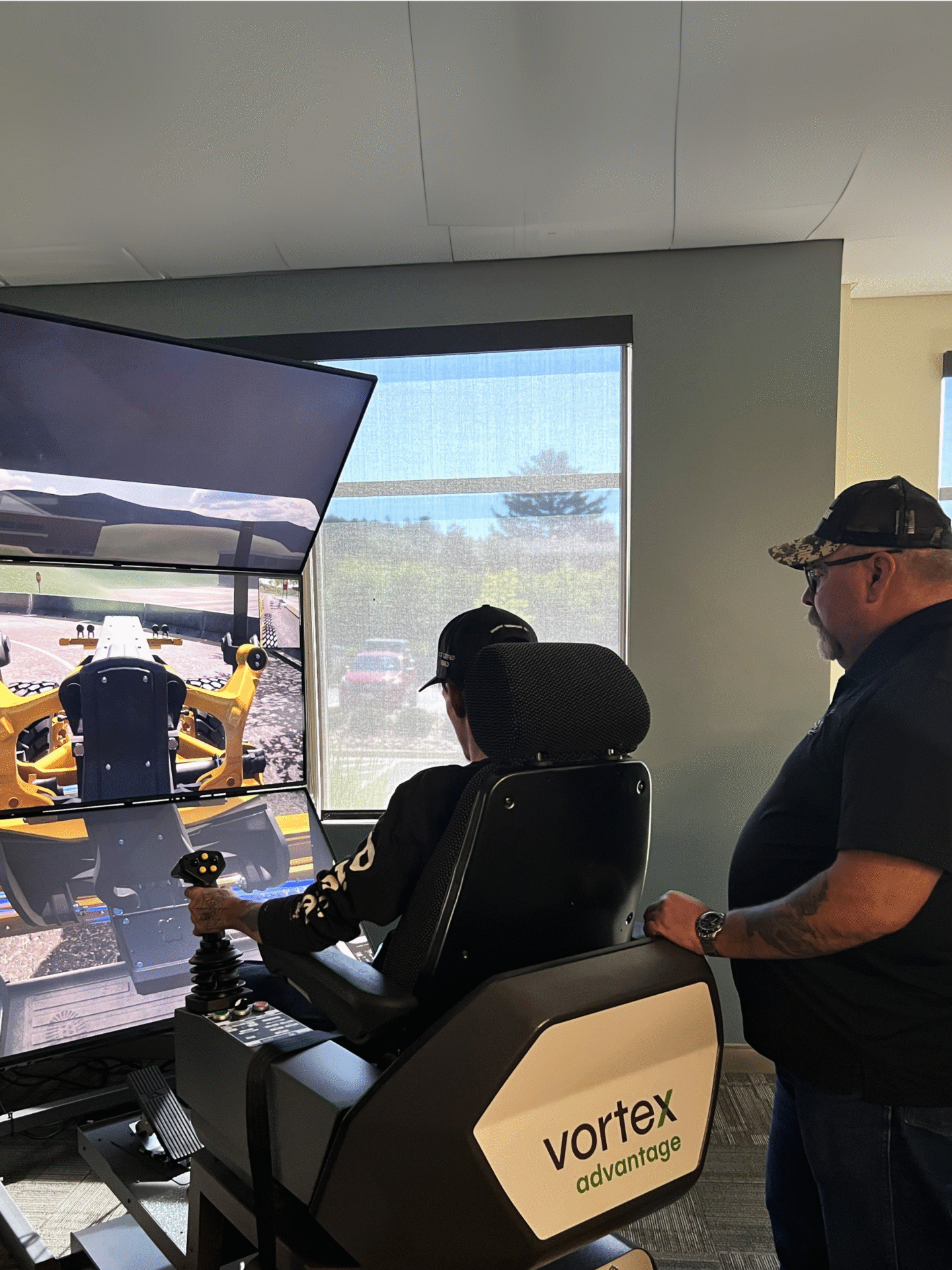 Dan training a shop mechanic on the simulator