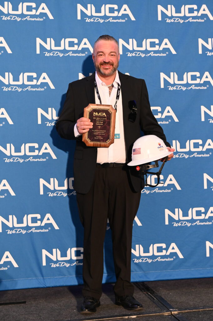 Larry Siebert accepts NUCA award on behalf of HEI Civil