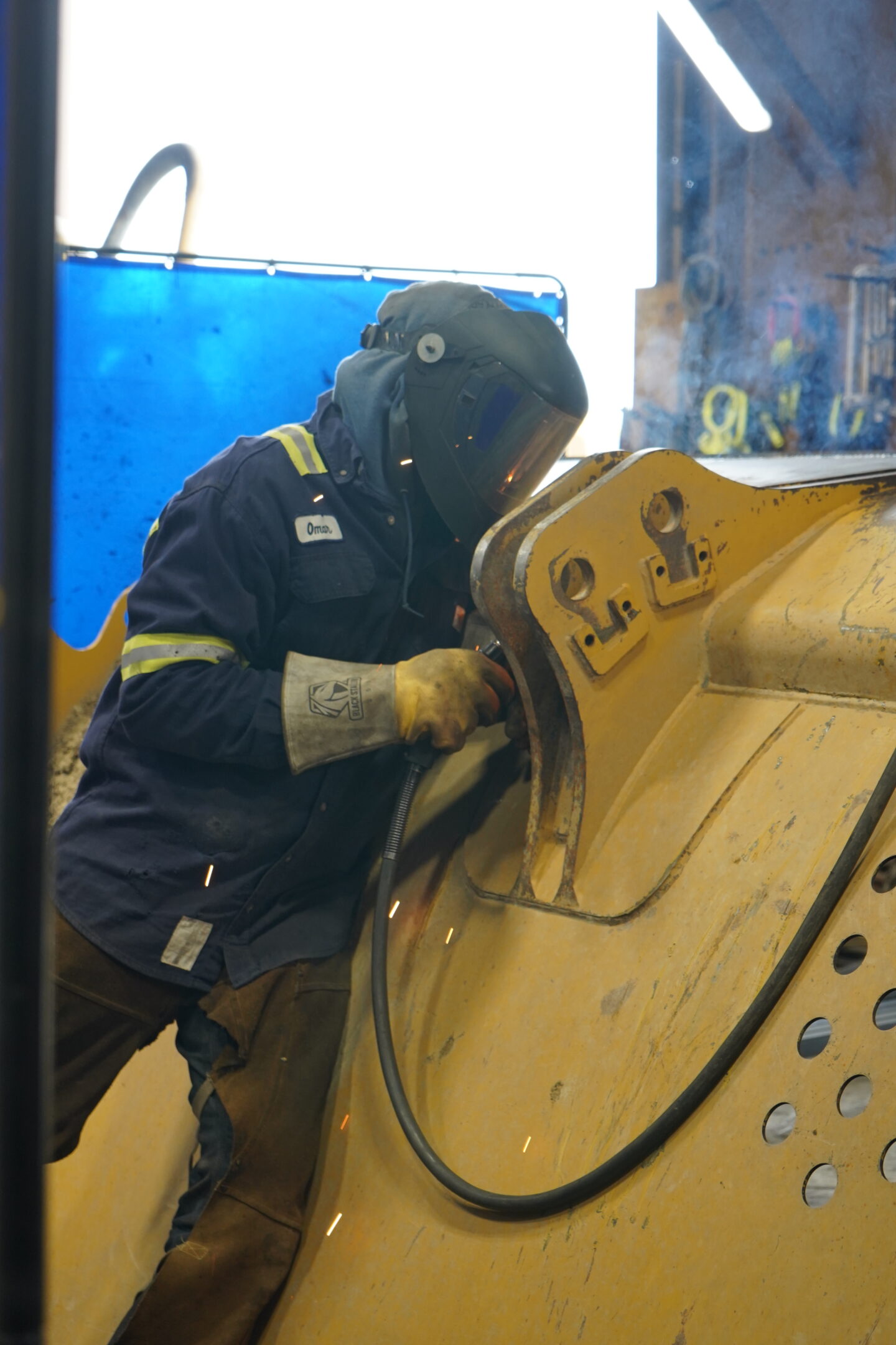 HEI Mechanic Working on Heavy Machinery