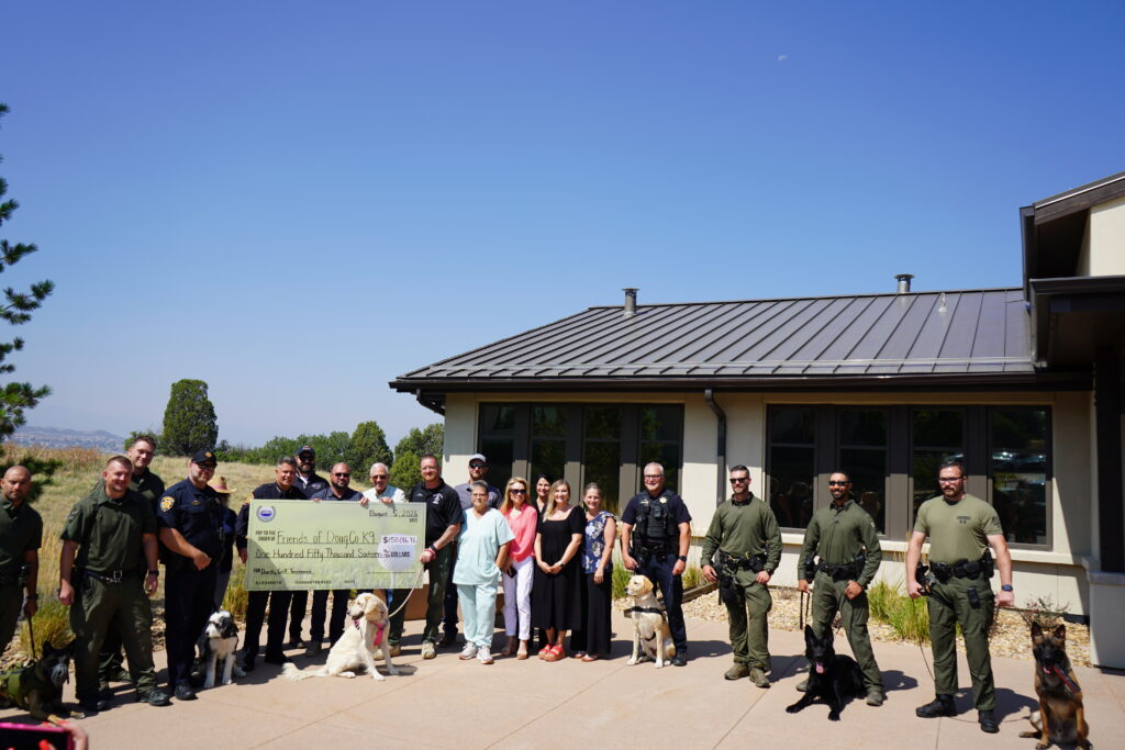 HEI Civil team members presented a giant check to members of Friends of Douglas County K-9 and the DCSO K-9 Unit